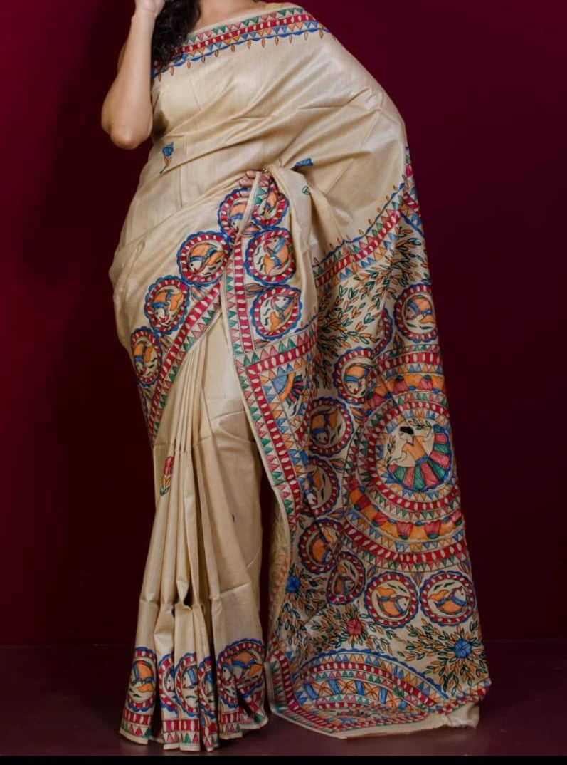 Beige saree with colorful patterns on a dark background