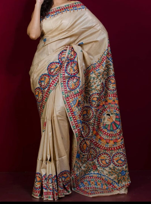 Beige saree with colorful patterns on a dark background
